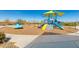 Community playground with play structures, swings, and a shaded area at 11682 W Parkway Ln, Avondale, AZ 85323