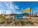 Community playground with shade sails and play structures at 11682 W Parkway Ln, Avondale, AZ 85323