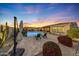 Stunning backyard oasis with a sparkling pool, patio, and relaxing seating area at 18125 W Acacia Dr, Goodyear, AZ 85338