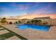 Stunning backyard oasis featuring a sparkling pool and spa, perfect for relaxation at 18125 W Acacia Dr, Goodyear, AZ 85338