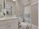 Clean bathroom with a shower/tub combo, white vanity, and tile flooring at 18125 W Acacia Dr, Goodyear, AZ 85338
