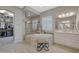 Bathroom with a large soaking tub, walk-in shower, and and vanities at 18125 W Acacia Dr, Goodyear, AZ 85338