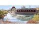 Estrella community entrance with a scenic water feature and stonework at 18125 W Acacia Dr, Goodyear, AZ 85338