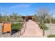 Attractive community entrance with stairs and bridge leading to clubhouse at 18125 W Acacia Dr, Goodyear, AZ 85338