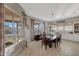 Bright dining room features a large table, chandelier, and views of the backyard at 18125 W Acacia Dr, Goodyear, AZ 85338