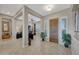 Bright and spacious entryway with tile floors and a view to the office at 18125 W Acacia Dr, Goodyear, AZ 85338