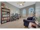 Bright home office features built-in shelving, desk, and comfortable seating at 18125 W Acacia Dr, Goodyear, AZ 85338