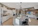 Open kitchen with large island, granite counters, and stylish light fixtures at 18125 W Acacia Dr, Goodyear, AZ 85338