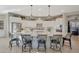 Modern kitchen with large island, stainless steel appliances, and white cabinets at 18125 W Acacia Dr, Goodyear, AZ 85338