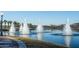 Tranquil lake scene with water fountains in a community setting at 18125 W Acacia Dr, Goodyear, AZ 85338