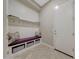 Convenient laundry room with built-in bench and storage at 18125 W Acacia Dr, Goodyear, AZ 85338