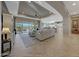 Spacious living room with large windows, tile floors, and access to backyard at 18125 W Acacia Dr, Goodyear, AZ 85338