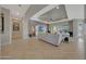Open living room features tile flooring and a large TV at 18125 W Acacia Dr, Goodyear, AZ 85338