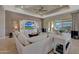 Bright living room with sectional sofa and large windows overlooking patio at 18125 W Acacia Dr, Goodyear, AZ 85338