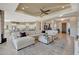 Open concept living room and kitchen with large sectional sofa and breakfast bar at 18125 W Acacia Dr, Goodyear, AZ 85338