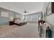 Main bedroom with a king bed, ceiling fan, and views of the backyard at 18125 W Acacia Dr, Goodyear, AZ 85338