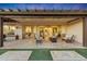 Spacious covered patio with fire pit and seating area at 18125 W Acacia Dr, Goodyear, AZ 85338