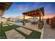 Outdoor patio with pergola, dining area, and built-in BBQ at 18125 W Acacia Dr, Goodyear, AZ 85338