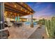 Large covered patio with dining area and built-in grill next to the pool at 18125 W Acacia Dr, Goodyear, AZ 85338