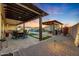 Relaxing patio space with pergola, fire pit, and dining area at 18125 W Acacia Dr, Goodyear, AZ 85338