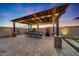 Outdoor patio with pergola, dining table, and built-in grill at 18125 W Acacia Dr, Goodyear, AZ 85338