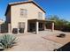 Desert landscape with covered patio, fire pit, and mature plants at 21963 W Gardenia Dr, Buckeye, AZ 85326