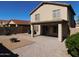 Home's backyard with fire pit and covered patio at 21963 W Gardenia Dr, Buckeye, AZ 85326