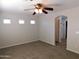 Primary bedroom with ceiling fan and ensuite bath at 21963 W Gardenia Dr, Buckeye, AZ 85326