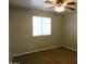 A bedroom featuring carpet, a window, and a ceiling fan at 21963 W Gardenia Dr, Buckeye, AZ 85326