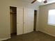 Bedroom with sliding closet doors and ample hanging space at 21963 W Gardenia Dr, Buckeye, AZ 85326