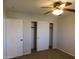 A bedroom with carpet, double closets and ceiling fan at 21963 W Gardenia Dr, Buckeye, AZ 85326