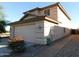 View of the house's side, showing the garage and walkway at 21963 W Gardenia Dr, Buckeye, AZ 85326