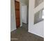 Clean hallway with neutral walls, carpet flooring, and access to other rooms at 21963 W Gardenia Dr, Buckeye, AZ 85326