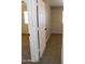 A hallway with carpet flooring and doors to bedrooms at 21963 W Gardenia Dr, Buckeye, AZ 85326