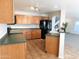 Well-equipped kitchen featuring wood cabinets and dark countertops at 21963 W Gardenia Dr, Buckeye, AZ 85326