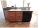 Kitchen with dark countertops, wood cabinets, and a dishwasher at 21963 W Gardenia Dr, Buckeye, AZ 85326