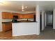 Kitchen with wood cabinets, dark countertops, and a breakfast bar at 21963 W Gardenia Dr, Buckeye, AZ 85326
