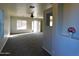 Bright living room with carpet, a ceiling fan, and sliding glass doors at 21963 W Gardenia Dr, Buckeye, AZ 85326