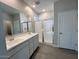 Main bathroom with double vanity, quartz countertop, and large walk-in shower at 23246 W Miami St, Buckeye, AZ 85326