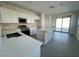 Modern kitchen featuring white cabinets, quartz countertops, and stainless steel appliances at 23246 W Miami St, Buckeye, AZ 85326