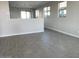 Open living area with wood-look tile flooring and neutral wall colors at 23246 W Miami St, Buckeye, AZ 85326