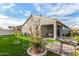 Landscaped backyard with covered patio and grill at 24413 W Raymond St, Buckeye, AZ 85326