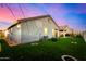 Charming backyard with artificial turf, covered patio, and grill at 24413 W Raymond St, Buckeye, AZ 85326