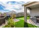 Backyard oasis with grill, patio furniture, and artificial turf at 24413 W Raymond St, Buckeye, AZ 85326