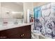 Clean bathroom with dark wood vanity and shower at 24413 W Raymond St, Buckeye, AZ 85326