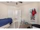 Bedroom with twin bed, and access to hallway at 24413 W Raymond St, Buckeye, AZ 85326