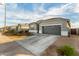Single-story home with gray exterior, two-car garage, and landscaping at 24413 W Raymond St, Buckeye, AZ 85326