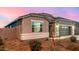 Single-story home with gray exterior, two-car garage, and landscaped yard at 24413 W Raymond St, Buckeye, AZ 85326