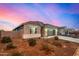 Single-story home with gray exterior, two-car garage, and landscaped yard at 24413 W Raymond St, Buckeye, AZ 85326