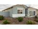 Single-story home with gray exterior, two-car garage, and landscaped yard at 24413 W Raymond St, Buckeye, AZ 85326